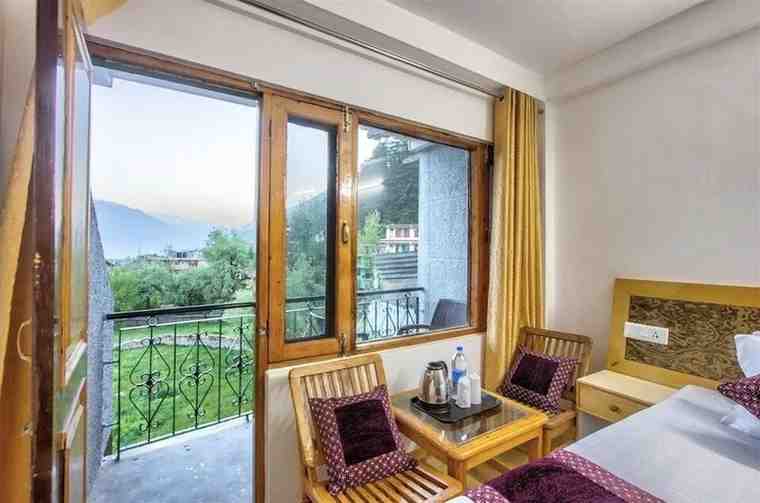 Room and balcony view of Hotel Solitaire Manali
